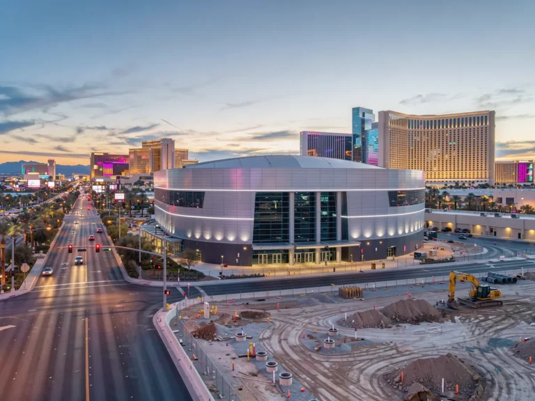 Concept image of a basketball arena beside Las Vegas Strip casino towers at dusk
