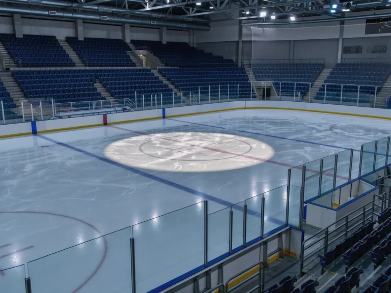 Empty ice hockey rink with blank advertising boards along the boards