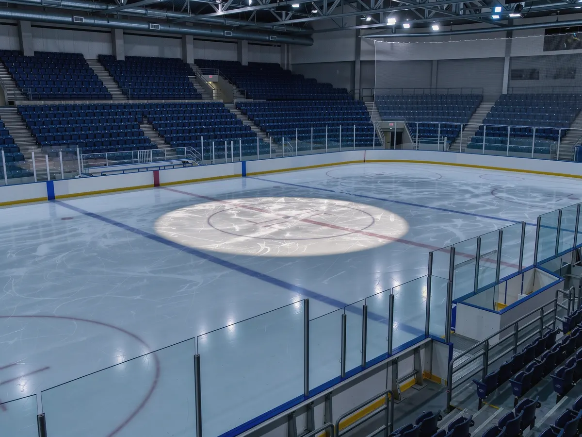 Empty ice hockey rink with blank advertising boards along the boards